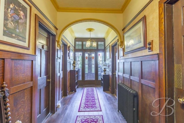 How about this for a spectacular way to start our tour of the Lichfield Lane property? A grand entrance hall with traditional wood panelling, a cast-iron radiator and solid oak flooring.