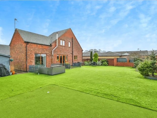 This attractive walled garden offers an Astroturf laid lawn, mini putting green, a substantial paved terrace, stocked borders and a garden store.