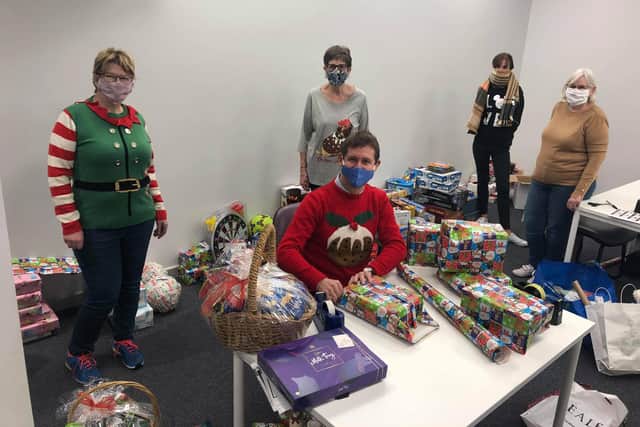 Mayor Andy Abrahams wrapping gifts with the elves (front of house staff from the Palace Theatre)