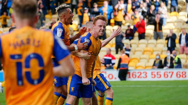 Mansfield Town's players celebrate their dramatic winner. Pic by The Bigger Picture.