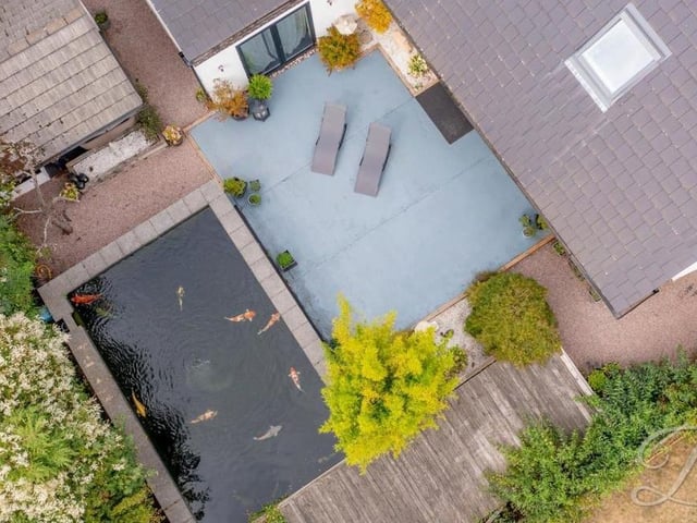 This bird's eye view of the Forest Town property hovers over the seating area and the large feature pond in the garden at the back.
