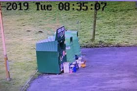 The camera shows rubbish dumped in the car park