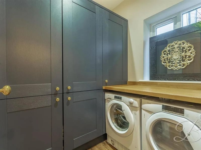 Complete with fitted units matching that of the kitchen, space and plumbing for both a washing machine and tumble dryer, worktop over, and a window to the side elevation.