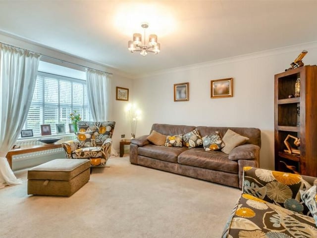 A third shot of the bright and comfortable lounge, which has coving to the ceiling, while double doors lead to the kitchen.
