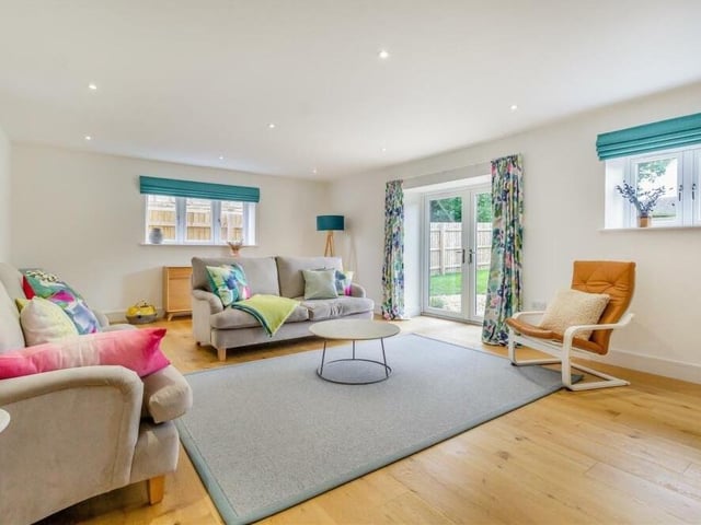 The first reception room to look at is this substantial and bright lounge, complete with French doors that lead out to the garden.