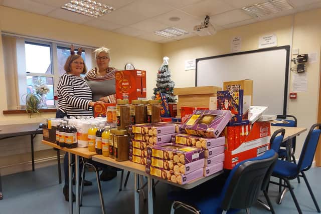 Anne Grew, community champion at Sainsbury's in Kimberley, hands over food donated by a generous anonymous customer to bureau manager Rachel Laurenson. Photo: Submitted