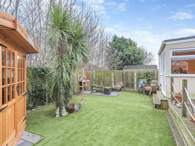 At the side of the property is an Indian sandstone patio with seating area. There is also space for storage.