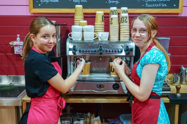 Staff members Madeleine Burns and Alicia Moss-Burton prepare more coffees in the store.