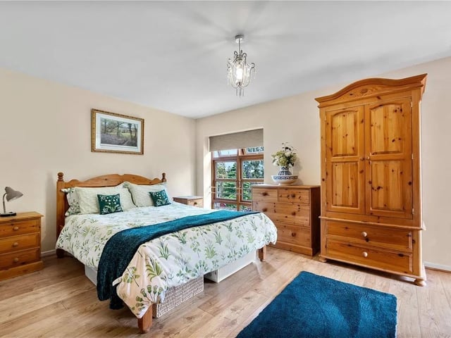 Feature windows to the side aspect, door leading to a private veranda, door leading to the en-suite, wooden flooring and a radiator.