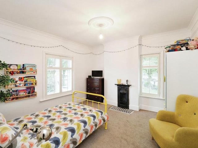 Moving on to the next bedroom on the first floor. It is a bonny and bright space, distinguished by another feature fireplace.