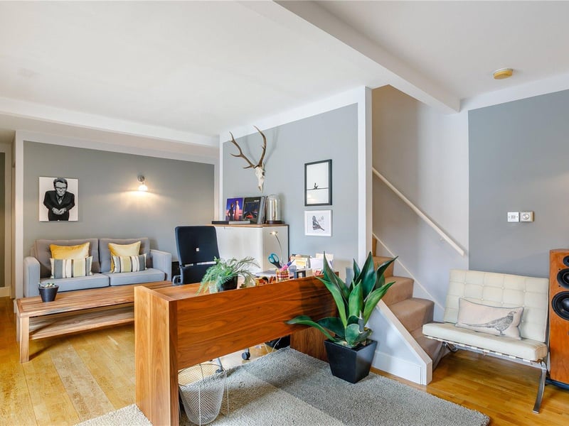 The generous study features oak flooring, a partitioned storage room and a casual seating area.