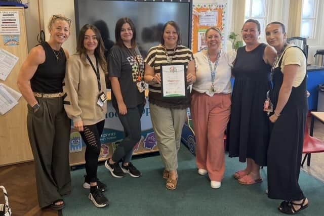 Staff at Kingsway School show off their Platinum OPAL (Outdoor Play and Learning) Award.