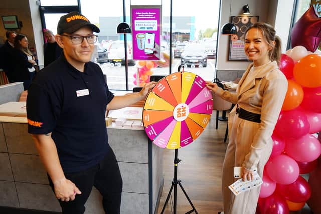 Opening of new Dunkin' donuts. Josh Illston working on spin the wheel with Jasmine Sheppard spinning the wheel.