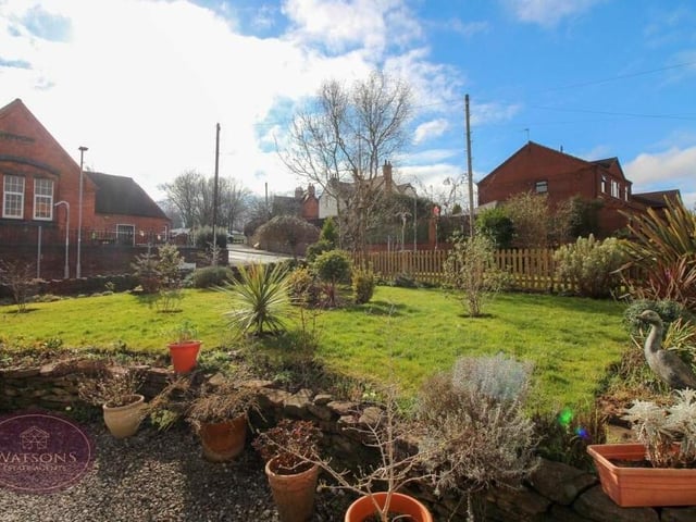 The front garden is admired by all the neighbours. It features a well-maintained lawn, flowerbed borders and a range of plants and shrubs.