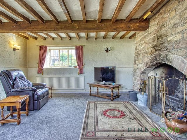 The home is brimming with traditional features, including exposed beams and fireplaces