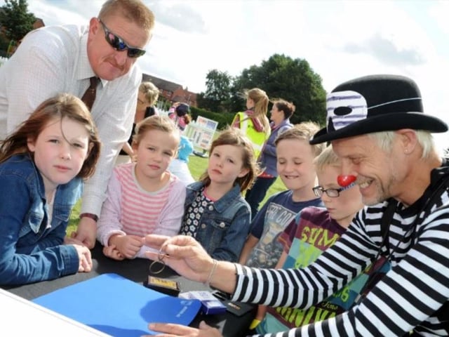 Visitors young and old are kept entertained by Bangers the clown at the Carr Lane Park summer festival in 2014.