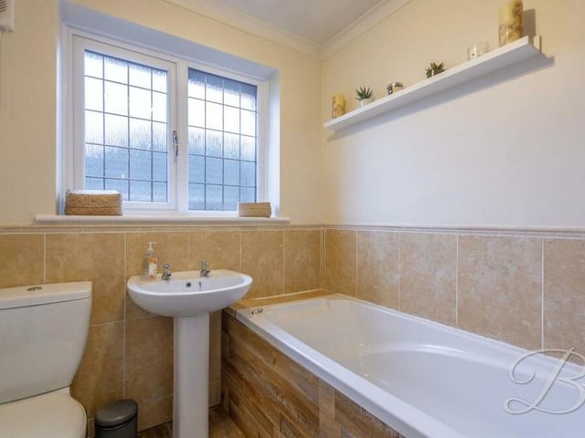 Serving three of the four bedrooms on the first floor is this modern family bathroom. It comprises a panelled bath, hand wash basin and low-flush WC.