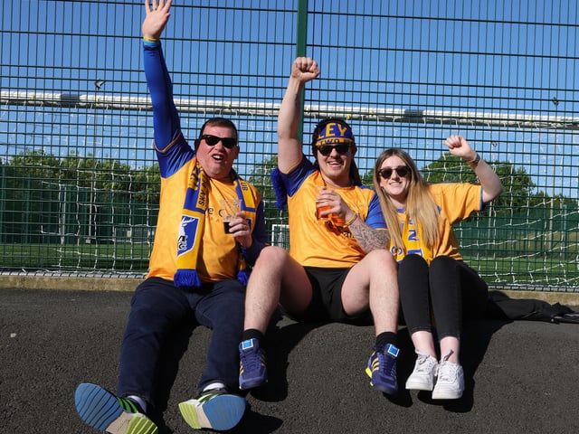 Fans await the buses for Wembley.