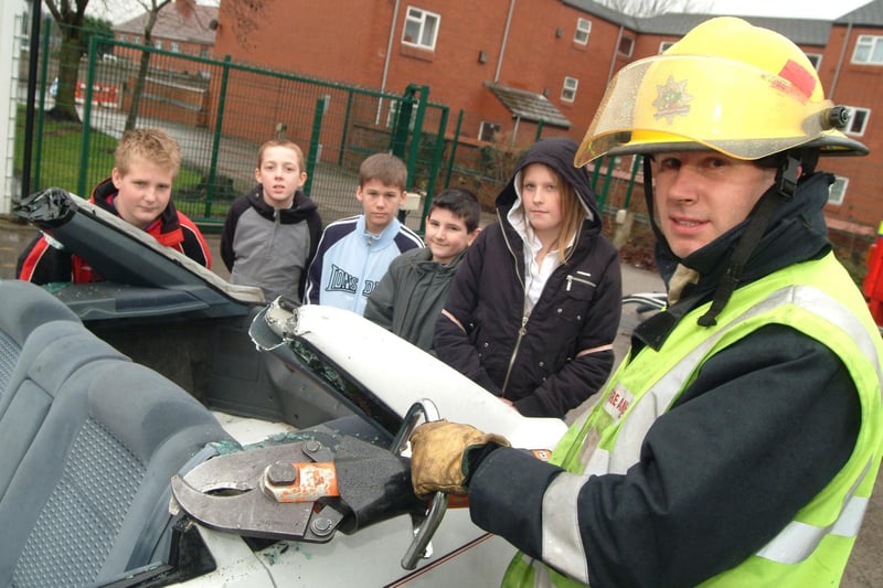 Firefighters demonstrated how they deal with RTAs. Pictured; Russ Dolby (firefighter) with local kids in 2007.