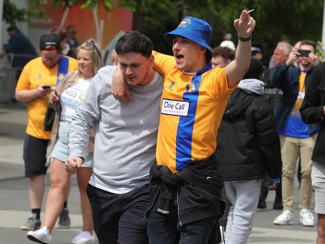 Mansfield Town fans watch the drama unfold inside Wembley.