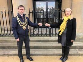 Mayor Andy Abrahams and strategic director Mariam Amos light candles and led a minute's silence in Mansfield Market Place.