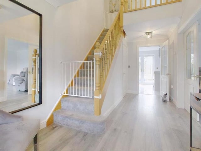 As you progress down the hallway, appreciating immediately the property's underfloor heating, there are the stairs on your left. But we need to take a look at the ground floor first.