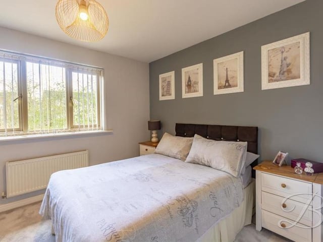 Both bedrooms are well appointed and of a similar size. This is the first one, which overlooks the back of the £140,000-plus property. There is carpet to the flooring and a central heating radiator.