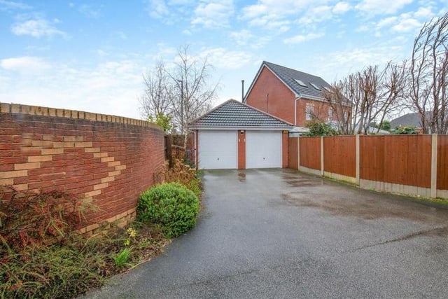 One of the property's two driveways leads to this impressive, detached double garage, which is equipped with power and light and boasts remote-controlled, electric up-and-over doors. There is also a side-entrance door and useful storage space in its loft area.