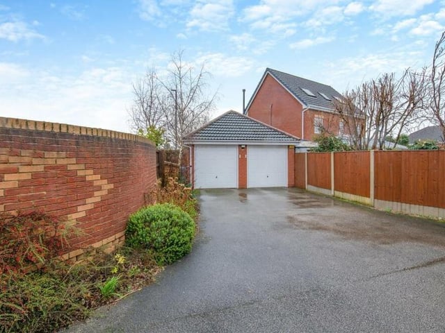 One of the property's two driveways leads to this impressive, detached double garage, which is equipped with power and light and boasts remote-controlled, electric up-and-over doors. There is also a side-entrance door and useful storage space in its loft area.