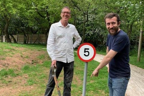 Councillors Sam Boneham (right) and Neil Doherty installed new speed limit signs at the park.