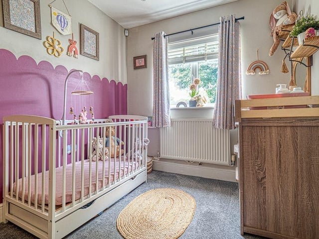 This bedroom is used as a child's nursery and includes a store cupboard.
