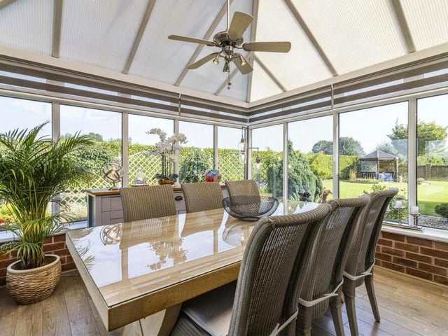 Flowing seamlessly from the sitting room is this conservatory, which has windows and French doors offering views of, and access to, the landscaped rear garden. It can also be used as a dining area.