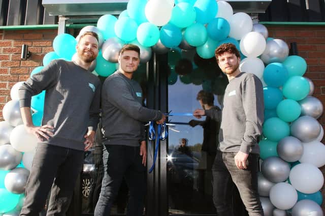 Alan, Jack and Adam Burnett cutting the ribbon the new Complete Kitchens showroom on Saturday, October 22.