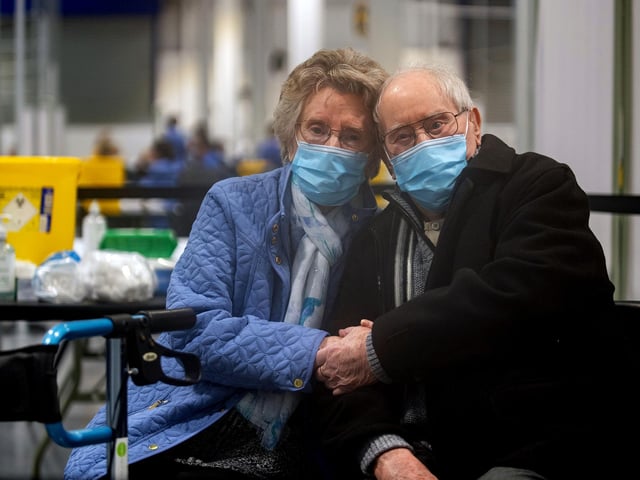 Geoff Holland, 90, and Jenny Holland, 86, from Mansfield after receiving their injections of the Oxford AstraZeneca Coronavirus vaccine at a former Wickes store in Mansfield, which is being used as a Covid vaccination centre on January 25, 2021.