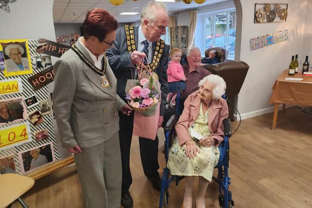 Ashfield District Council chairman David Walters and his consort Babs Walters presented flowers to Lillian.