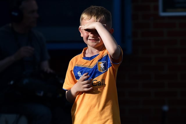A Mansfield Town fan shields his eyes from the sun.