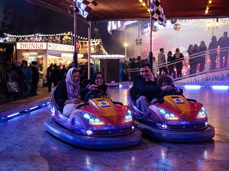 Visitors ride bumper cars at the fair in 2017.