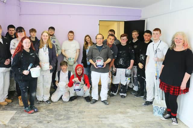 The painting and decorating students with Angie Peppard from Our Centre, right.