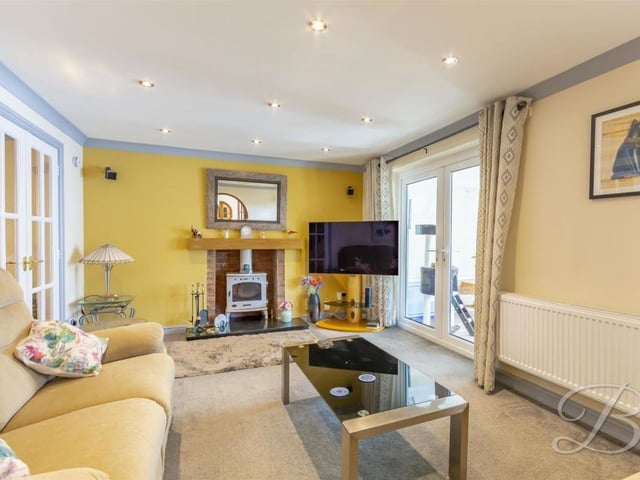 From one enchanting room to another. Here is the living room, which provides a cosy setting to settle down of an evening in front of the TV. The French doors lead to the conservatory at the back of the house.