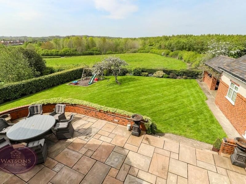 This shot from one of the bedroom windows shows the paved patio and turfed lawn that form part of the rear garden, and also the amazing countryside views.