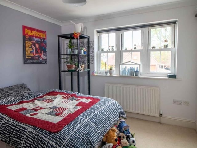 Bedroom number two is at the front of the house with a built-in wardrobe and a door that leads directly into the family bathroom.