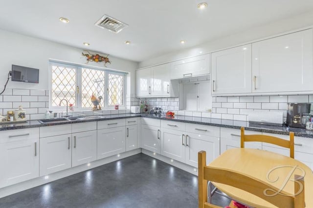The bungalow's kitchen is a true stunner, having been wonderfully modernised. It features an extensive range of modern, white gloss units and cabinets, with work surfaces over, an inset sink and drainer, splashback tiles and under-cupboard lighting. There is plenty of room for a breakfast table.