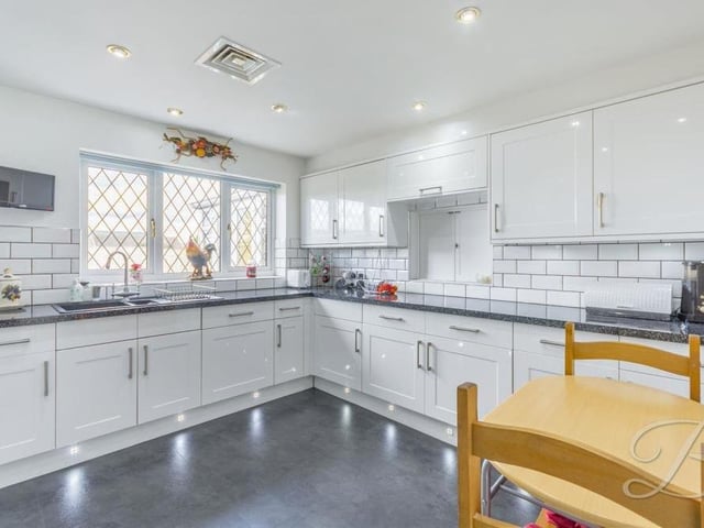 The bungalow's kitchen is a true stunner, having been wonderfully modernised. It features an extensive range of modern, white gloss units and cabinets, with work surfaces over, an inset sink and drainer, splashback tiles and under-cupboard lighting. There is plenty of room for a breakfast table.