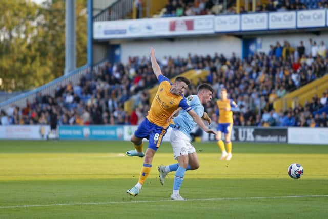 Mansfield Town midfielder Ollie Clarke in the thick of it tonight. Photo by Chris HOLLOWAY / The Bigger Picture.media
