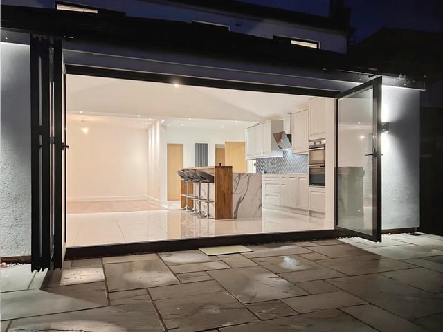 The bifold doors open onto the patio, perfect for alfresco entertaining.