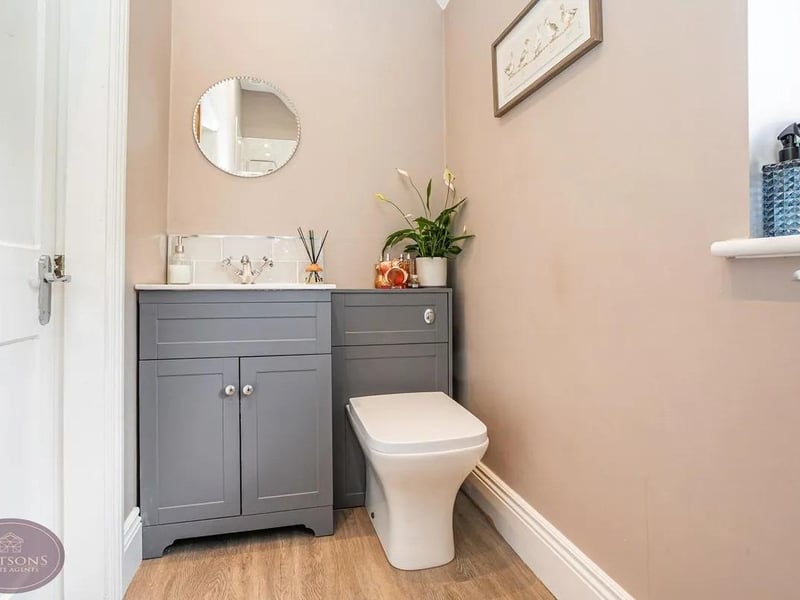 A convenient WC with concealed flush WC and vanity sink unit.