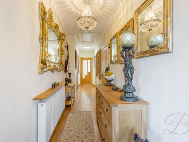 This long and welcoming hallway links most of the rooms within the bungalow. It is a delightful space, full of character.