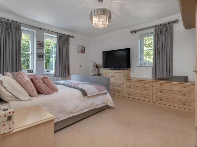 And so on to the six bedrooms, which can be found on the first and second floors of the £975,000 house. Here is the large, dual-aspect master, which boasts fitted wardrobes with hanging rails and shelves, plus a separate, fitted dressing table with extensive drawers.