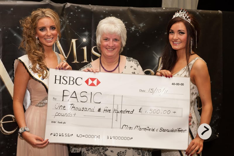 The outgoing Miss Mansfield & Sherwood Forest Chelsea Edgington, left, presents a cheque for £1,500 to PASIC co-ordinator, Bea Brunton, along with the newly-crowned Alicia Caley