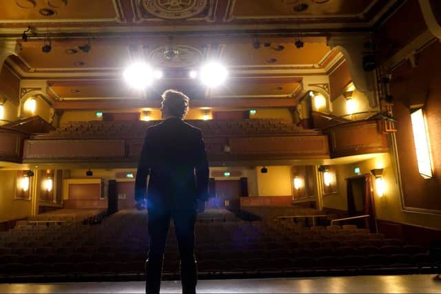 Chris Miggells on stage at Palace Theatre
